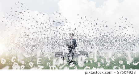 Young businessman or student studying the science and symbols fly around Young businessman or student studying the science and symbols fly around 57504928