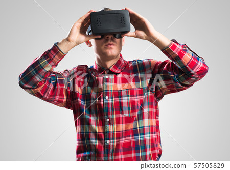 Guy in mask experiencing virtual reality as new entertainment device Guy in mask experiencing virtual reality as new entertainment device 57505829
