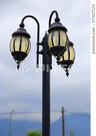 Vintage street lamp against a cloudy sky 57507529