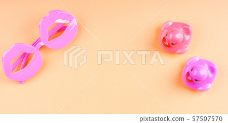 Lip shape glasses and rubber ducks on orange Lip shape glasses and rubber ducks on orange 57507570