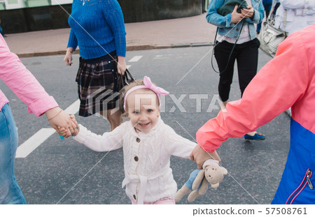 Happy mother and her children are walking around 57508761