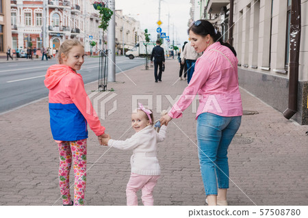 Happy mother and her children are walking around Happy mother and her children are walking around 57508780