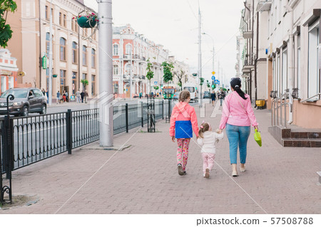 Happy mother and her children are walking around Happy mother and her children are walking around 57508788