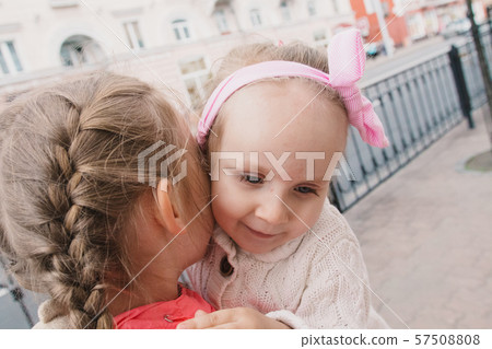Children walk down the street and smile Children walk down the street and smile 57508808