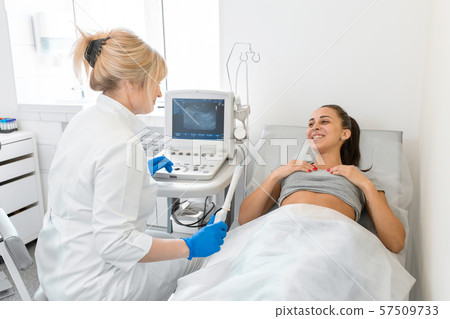 The gynecologist sets up the ultrasound machine 57509733