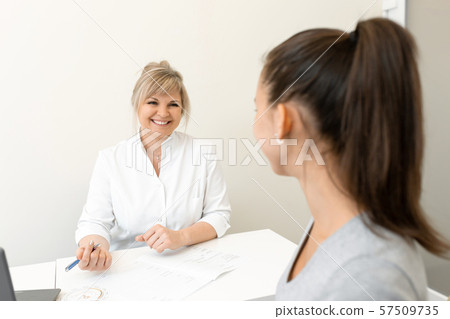 Beautiful woman gynecologist is conducting a Beautiful woman gynecologist is conducting a 57509735
