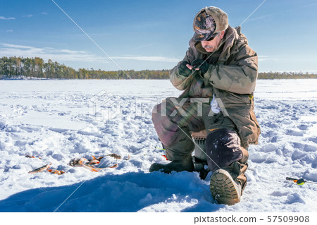 winter fishing Fisherman enjoying a day on the ice 57509908