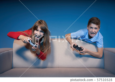 Computer game competition. Gaming concept. Excited girl playing video game with joystick 57510328