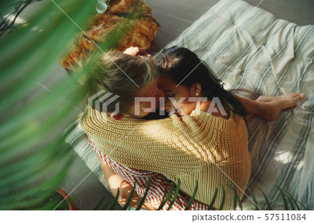 Couple of lovers at home relaxing together, comfortable Couple of lovers at home relaxing together, comfortable 57511084