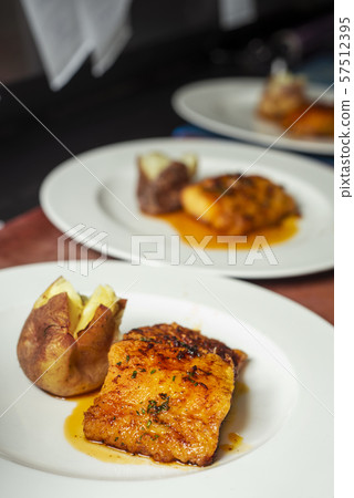 plates with battered cod and roasted potatoes plates with battered cod and roasted potatoes 57512395
