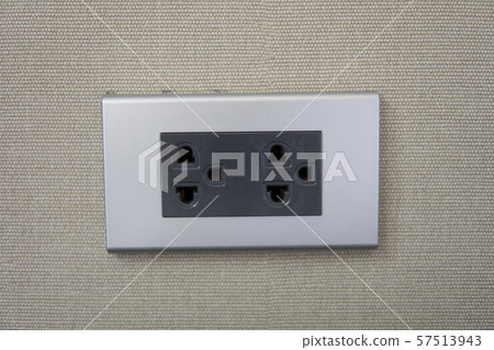 Grey universal electricity sockets plug on a yellow wall. Grey universal electricity sockets plug on a yellow wall. 57513943