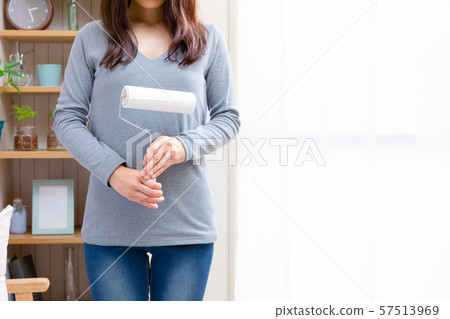 Woman with adhesive cleaner Woman with adhesive cleaner 57513969