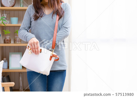 Woman searching for, fishing and organizing in a bag 57513980