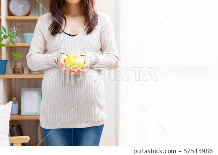 Pregnant woman with pears 57513986