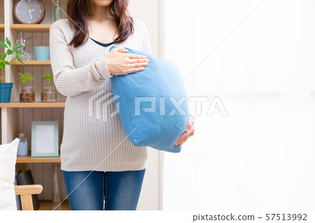 Pregnant woman with cushion Pregnant woman with cushion 57513992