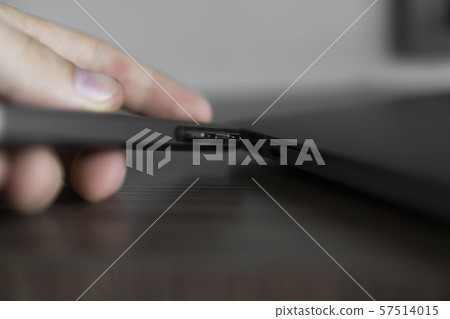 Man's hand holding The USB adapter under the Type-C connector for laptop. Multiport station for 57514015