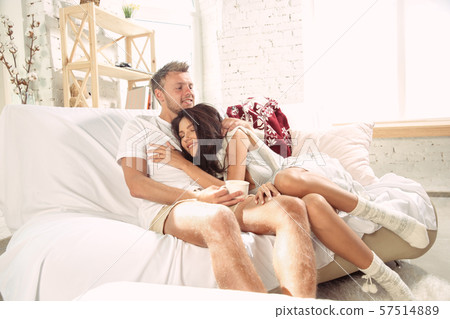 Couple of lovers at home relaxing together, comfortable Couple of lovers at home relaxing together, comfortable 57514889