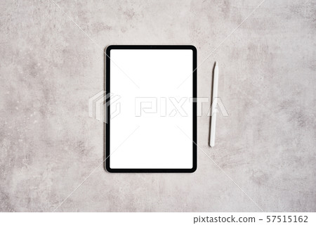 Tablet and pencil on grey concrete background. 57515162