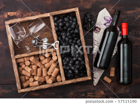 Bottles of red wine on wood with empty glasses 57515190