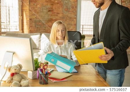 A young businesswoman moving in office, getting new work place A young businesswoman moving in office, getting new work place 57516037
