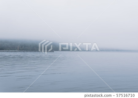mountain lake in late autumn in the fog mountain lake in late autumn in the fog 57516710