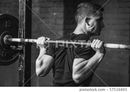 A nice muscular guy with a strong body. Exercises at the gym. Achievement of physical endurance and A nice muscular guy with a strong body. Exercises at the gym. Achievement of physical endurance and 57516893