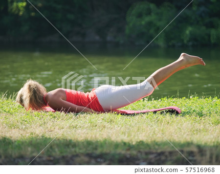 Woman Doing Yoga in the Park Woman Doing Yoga in the Park 57516968