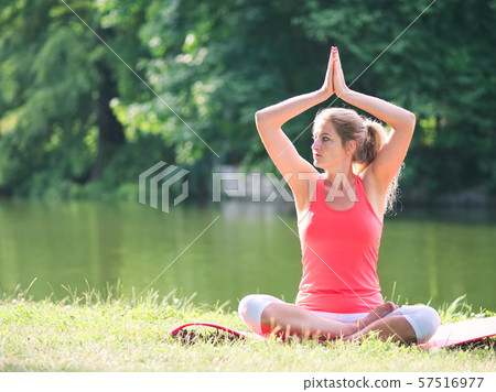Woman Doing Yoga in the Park 57516977
