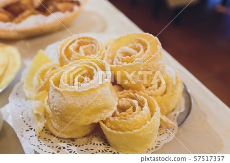Russian traditional cookies Brushwood in a white plate on white wooden table close-up, selective Russian traditional cookies Brushwood in a white plate on white wooden table close-up, selective 57517357