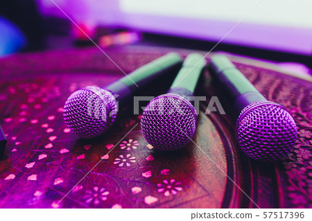 three Microphones in group on red table with copy space. three Microphones in group on red table with copy space. 57517396