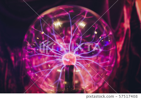 Hand touching a plasma ball with smooth magenta-blue flames. Hand touching a plasma ball with smooth magenta-blue flames. 57517408