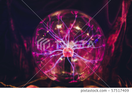 Hand touching a plasma ball with smooth magenta-blue flames. Hand touching a plasma ball with smooth magenta-blue flames. 57517409