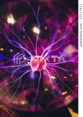 Hand touching a plasma ball with smooth magenta-blue flames. Hand touching a plasma ball with smooth magenta-blue flames. 57517411