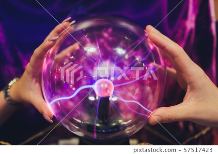 Hand touching a plasma ball with smooth magenta-blue flames. Hand touching a plasma ball with smooth magenta-blue flames. 57517423