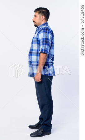Full body shot profile view of bearded Persian hipster man 57518458