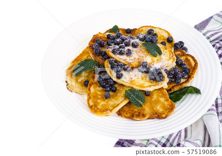 Tasty sweet pancakes with sugar and blueberries Tasty sweet pancakes with sugar and blueberries 57519086