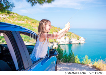 Little girl on vacation travel by car background beautiful landscape 57519286