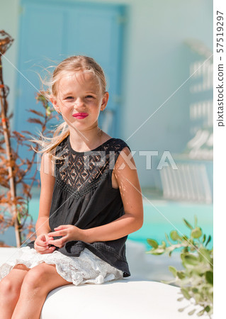 Adorable little girl at old street of typical greek traditional village 57519297