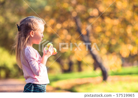 Adorable little girl at beautiful autumn day outdoors Adorable little girl at beautiful autumn day outdoors 57519965
