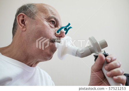 Senior hispanic man man testing breathing function by spirometry Senior hispanic man man testing breathing function by spirometry 57521253
