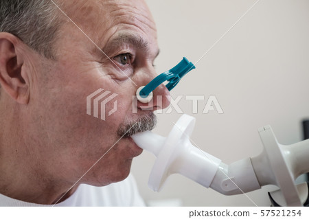 Senior hispanic man man testing breathing function by spirometry Senior hispanic man man testing breathing function by spirometry 57521254