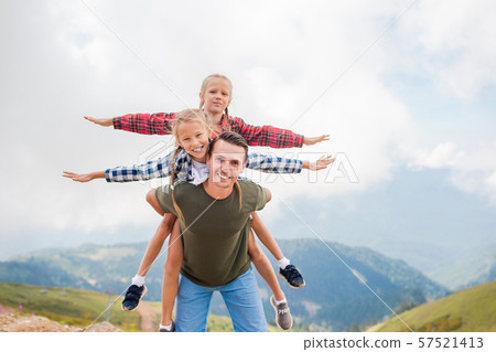 Beautiful kids and happy man in mountains in the background of fog 57521413