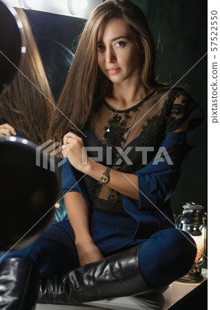 Sexy young brunette posing near a mirror Sexy young brunette posing near a mirror 57522550