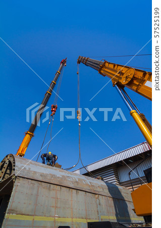TWo truck cranes working over dry dock are lifting TWo truck cranes working over dry dock are lifting 57525199