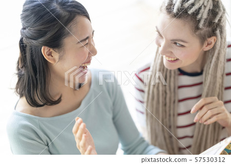 Japanese woman laughs laughing at foreign women and watching Japanese comics 57530312