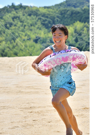 Girls running on the beach (sea bathing, bathing suit) Girls running on the beach (sea bathing, bathing suit) 57530968
