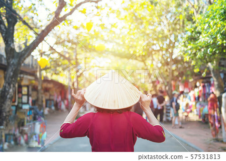 Asian woman in vietnamese dress hand touch hat Asian woman in vietnamese dress hand touch hat 57531813