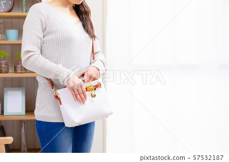 Woman searching for, fishing and organizing in a bag Woman searching for, fishing and organizing in a bag 57532187