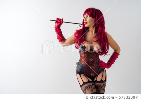 Dominant woman in a red wig corset and leather 57532397
