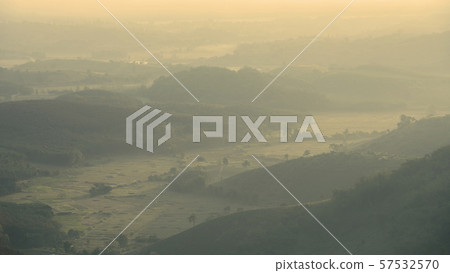 Forested mountain slope in low lying cloud with the evergreen conifers shrouded in mist in a scenic landscape view Forested mountain slope in low lying cloud with the evergreen conifers shrouded in mist in a scenic landscape view 57532570